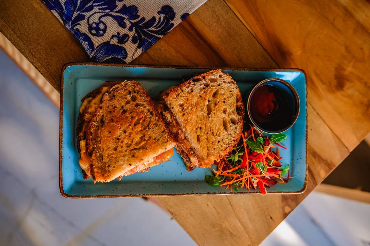 Grilled cheese sandwich served on a Mediterranean blue plate